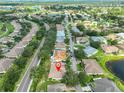 An aerial shot showcases the property's location within a community featuring golf courses and lakes at 1112 Mcdaniel St # 78, Sun City Center, FL 33573