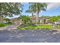 A well-maintained home with lush lawn, palm trees, and a brick-paved driveway offers great curb appeal at 1112 Mcdaniel St # 78, Sun City Center, FL 33573