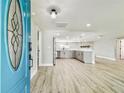 View from the entryway looking into an open floor plan, kitchen, and living area at 13909 Berkowitz Ave, Hudson, FL 34667