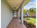 Inviting entryway featuring decorative mosaic tile flooring and stone accents at 13909 Berkowitz Ave, Hudson, FL 34667