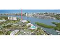Aerial view of waterfront condo building with docks, tennis courts, and community pool at 14800 Walsingham Rd # 1215, Largo, FL 33774