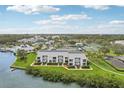 Exterior view of a condo building with waterfront access and manicured lawn at 14800 Walsingham Rd # 1215, Largo, FL 33774