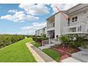 Exterior view of condo featuring a balcony and well-maintained landscaping at 14800 Walsingham Rd # 1215, Largo, FL 33774