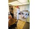 Well-lit kitchen features white appliances, tile floors, and ample cabinet space at 1620 58Th N Ave # 6, St Petersburg, FL 33712