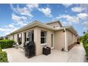 Outdoor patio featuring a grill, bench, and view of the home's exterior and manicured landscaping at 1626 Terra Ceia Bay Cir # 6, Palmetto, FL 34221