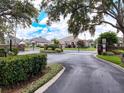Gated community entrance provides security and curb appeal with lush landscaping and brick pillars at 22925 Collridge Dr, Land O Lakes, FL 34639