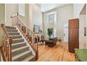 Spacious living room featuring a fireplace, staircase, high ceilings, and ample natural light at 3304 W Harbor View Ave, Tampa, FL 33611