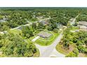 Aerial view of a home nestled in a lush, wooded neighborhood with mature trees providing ample privacy at 3682 Johnstown St, North Port, FL 34288