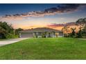 Beautiful single-story home with a well-manicured lawn and a spacious two-car garage at 3682 Johnstown St, North Port, FL 34288