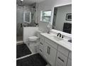 Renovated bathroom featuring marble shower, modern vanity with backlit mirror and stylish fixtures at 4029 9Th S Ave, St Petersburg, FL 33711