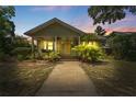 Twilight view of the inviting front exterior of this charming bungalow at 4220 2Nd N Ave, St Petersburg, FL 33713