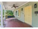 Inviting front porch with swing, fan, and a pop of color from the yellow door at 4220 2Nd N Ave, St Petersburg, FL 33713