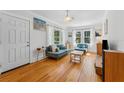 Bright living room featuring hardwood floors, large windows, and cozy furniture at 4220 2Nd N Ave, St Petersburg, FL 33713