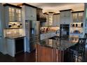 Gourmet kitchen features granite countertops, stainless steel appliances, wine storage, and a central island at 4495 Secretariat Run, Spring Hill, FL 34609