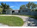 Single-story house with front yard, driveway, attached garage, and a charming picket fence at 4591 54Th N Ave, St Petersburg, FL 33714