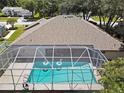 Aerial view showcasing a private screened pool with swan floats, perfect for relaxation and enjoying the outdoors at 4617 Basswood St, Land O Lakes, FL 34639