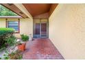 Covered brick front entrance with a screened door and decorative potted plants at 4709 Heath Ave, Tampa, FL 33624