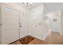 Bright entryway features double doors, wood flooring, and access to other rooms at 4712 Coachmen Rd, New Port Richey, FL 34655