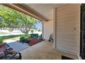 Cozy porch area with brick flooring and views of the landscaped front yard at 4712 Coachmen Rd, New Port Richey, FL 34655