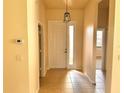 Bright foyer with tile flooring, leading to the interior of the home at 4950 Sandy Brook Cir, Wimauma, FL 33598