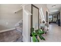 Welcoming entryway with stairs, a large mirror, and stylish decor, setting a sophisticated tone at 5522 Appleton Shore Dr, Apollo Beach, FL 33572