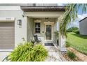 Inviting front porch featuring decorative plants, creating a cozy entrance to the home at 5522 Appleton Shore Dr, Apollo Beach, FL 33572