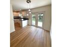 Eat-in-kitchen dining area with pendant lighting and sliding glass doors leading to the yard at 5644 Samter Ct, Tampa, FL 33611