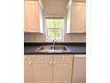 The kitchen features a double stainless steel sink underneath a bright window at 5644 Samter Ct, Tampa, FL 33611