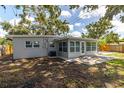 Backyard featuring a concrete patio, a fence, and mature trees, perfect for outdoor entertaining at 6334 22Nd N Ave, St Petersburg, FL 33710