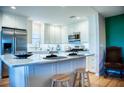 Modern kitchen with white cabinets, stainless steel appliances, marble countertop, and seating for casual dining at 7941 58Th N Ave # 301, St Petersburg, FL 33709