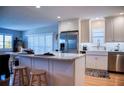 Contemporary kitchen featuring a breakfast bar, stainless steel refrigerator, white cabinets and lots of light at 7941 58Th N Ave # 301, St Petersburg, FL 33709