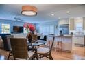 Bright open-concept living room with a dining area, kitchen, modern lighting and stylish furnishings throughout at 7941 58Th N Ave # 301, St Petersburg, FL 33709