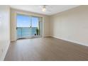 Light-filled bedroom boasts floor-to-ceiling windows with sliding doors leading to a private balcony at 7979 Sailboat Key S Blvd # 505, South Pasadena, FL 33707
