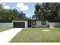 Attractive single-story home boasting fresh exterior paint, attached garage, and manicured front yard at 814 W 131St Ave, Tampa, FL 33612