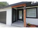 View of the front entrance with custom wood beam and updated hardware at 814 W 131St Ave, Tampa, FL 33612