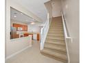 Bright kitchen area with tile flooring and a staircase view at 10208 Westpark Preserve Blvd, Tampa, FL 33625