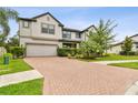 Charming two-story home with a brick driveway and well-maintained landscaping at 10701 Morning Dew Way, Tampa, FL 33647