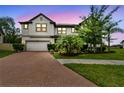 Beautiful two-story house with well-manicured lawn and garden at dusk at 10701 Morning Dew Way, Tampa, FL 33647