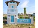 Lucaya Lake Club entrance featuring a blue and white coastal theme with lush landscaping at 12215 Blue Pacific Dr, Riverview, FL 33579