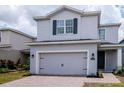 Beautiful two-story home with gray exterior, a two-car garage, and landscaped front yard for curb appeal at 12215 Blue Pacific Dr, Riverview, FL 33579