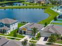 Beautiful home with a two-car garage, manicured lawn, and lake view at 12931 Twin Bridges Dr, Riverview, FL 33579