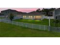 A manicured backyard with a well-maintained lawn and a white picket fence at 12931 Twin Bridges Dr, Riverview, FL 33579