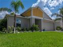 Beautiful home with a well-manicured lawn, lovely landscaping, and a two-car garage at 12931 Twin Bridges Dr, Riverview, FL 33579