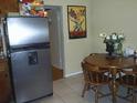 Eat-in kitchen features stainless steel refrigerator and table with seating at 1317 Tyrone N Blvd, St Petersburg, FL 33710