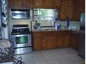 Functional kitchen with stainless steel appliances and wooden cabinetry at 1317 Tyrone N Blvd, St Petersburg, FL 33710