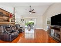 Expansive living area with hardwood floors, comfortable seating, and views to the patio at 14096 Pullman Dr, Spring Hill, FL 34609