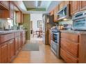 Functional kitchen with wood cabinets, stainless appliances, and plenty of counter space at 1610 Sanderling Ct, Brandon, FL 33511