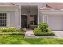 Inviting front entrance with decorative glass doors and manicured landscaping at 17807 Arbor Greene Dr, Tampa, FL 33647