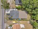 Aerial view of the property showcasing the house, driveway, yard, and surrounding neighborhood at 2108 E Linebaugh Ave, Tampa, FL 33612