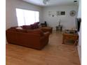 Bright living room with ample seating, laminate floors, and natural light, ideal for relaxation at 2239 Curtis S Dr, Clearwater, FL 33764